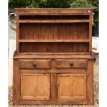 A 19TH CENTURY IRISH PINE DRESSER With open shelves above two drawers and cupboards (147cm x 45cm