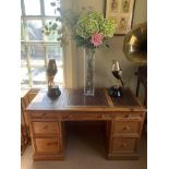 A VICTORIAN DESIGN PINE KNEEHOLE DESK With leather top over an arrangement of drawers, raised on