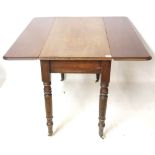 A 19TH CENTURY MAHOGANY PEMBROKE TABLE With single drawer raised on turned legs terminating on