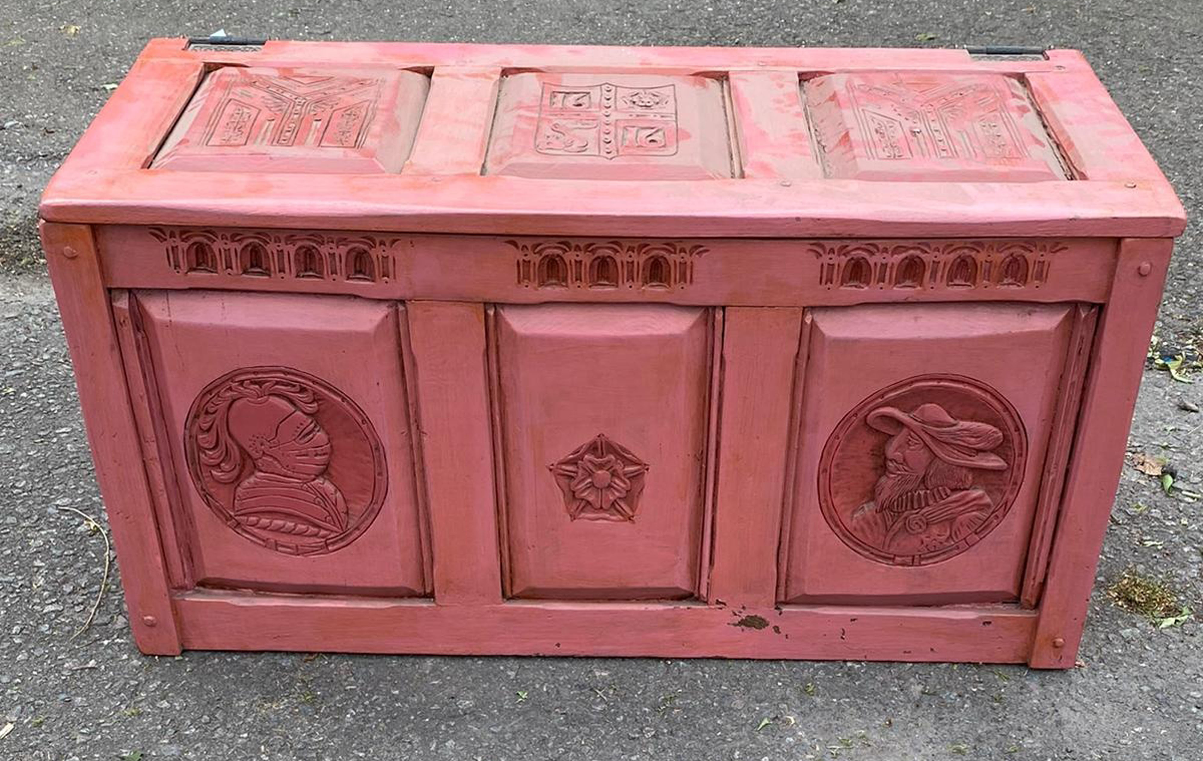 AN EARLY 20TH CENTURY FRENCH PAINTED OAK PANELLED COFFER Carved with coats of arms and facial