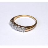 A 14CT GOLD AND DIAMOND FIVE STONE RING The graduated set of round cut diamonds (size O). (weight