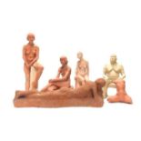A GROUP OF SIX TERRACOTTA AND WHITE CLAY STUDIO STATUES.