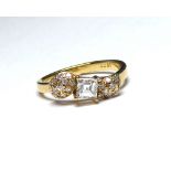 A 18K GOLD RING, CENTRALLY SET WITH 0.4CT SQUARE BAGUETTE CUT DIAMOND Flanked by diamond encrusted