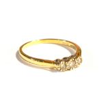 AN 18CT GOLD AND DIAMOND THREE STONE RING Having a row of graduating round cut stones (size S/T). (