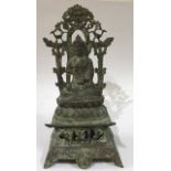 A CHINESE BRONZE BUDDHA Seated pose on double lotus leaf with pierced back and red wax seal to