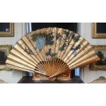 A LARGE 20TH CENTURY JAPANESE HAND PAINTED PAPER FAN Having a plain wooden frame and signed upper