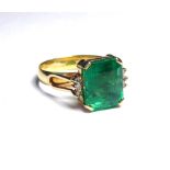 AN 18K GOLD RING SET WITH 5CT PRINCESS CUT EMERALD Flanked by diamonds (size N). weight approx 4.