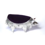 A LARGE CONTINENTAL SILVER NOVELTY PIN CUSHION Modelled as a pig with velvet cushion, marked .