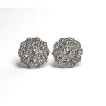 A PAIR OF 18K WHITE GOLD FLORAL DIAMOND ENCRUSTED EARRINGS. (diameter 1.3cm)