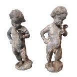 TWO ANTIQUE LEAD GARDEN STATUES OF PUTTI Each holding a lovebird. (approx 40cm)