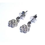 A PAIR OF 18K WHITE GOLD AND DIAMOND DAISY SET EARRINGS. (diamond weight 1.4ct) (diameter 1cm)