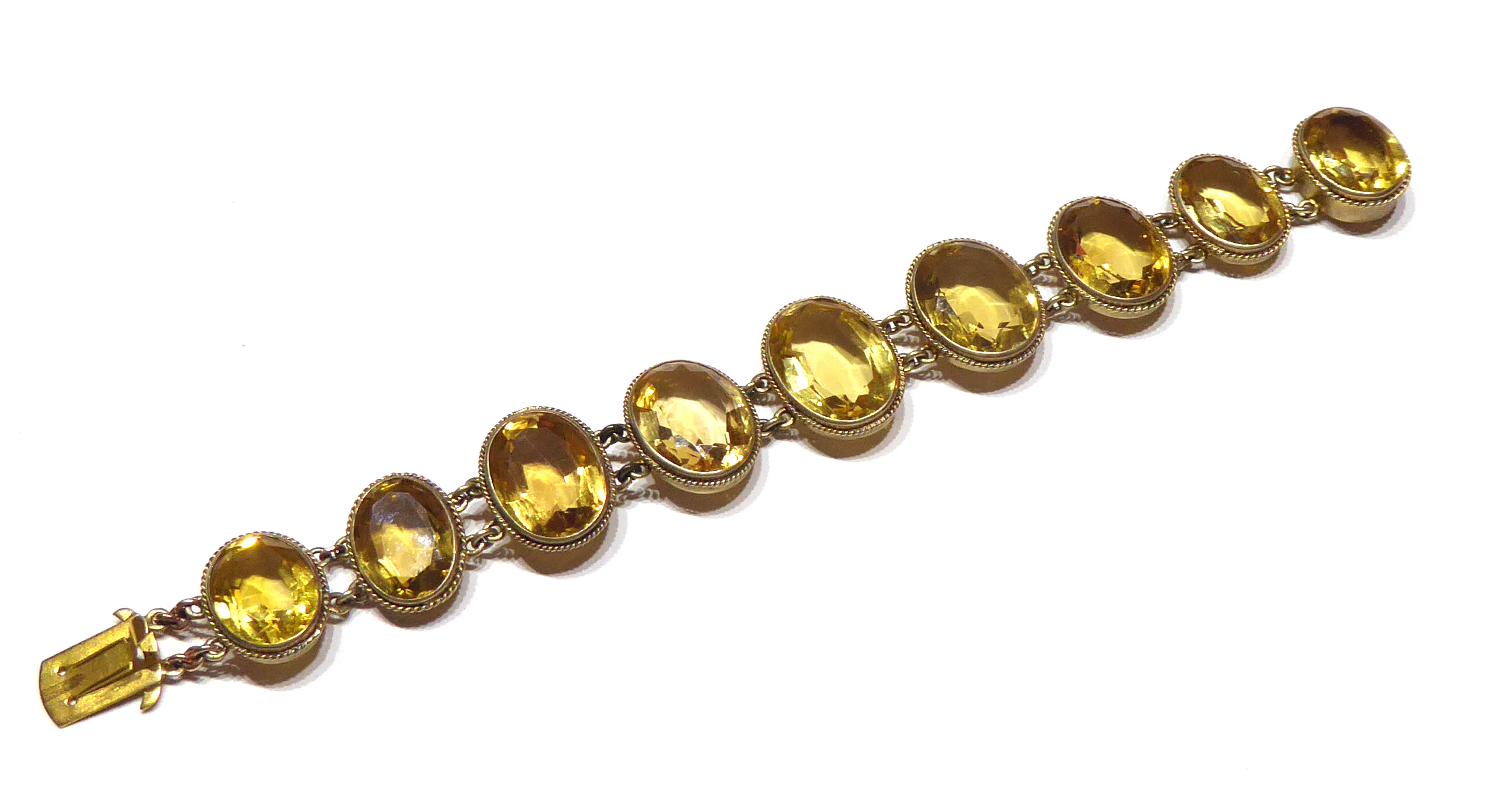 A VICTORIAN YELLOW METAL AND CITRINE BRACELET Having an arrangement of oval cut graduating