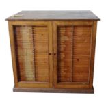 A VICTORIAN OAK SCIENTISTS COLLECTOR'S CABINET With two glazed doors enclosing 60 drawers, bearing