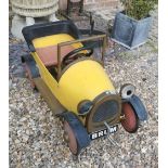 A CHILD'S BRUM PEDDLE CAR Steel body, brass running boards, headlights and grill. (95cm)