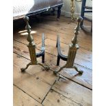 A PAIR OF 19TH CENTURY REGENCY PERIOD BRONZE FIRE DOGS With finals tops over reeded column, raised