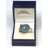 AN 18CT WHITE GOLD, BLUE CHALCEDONY AND DIAMOND RING Cabochon cut stone, flanked by diamonds in a