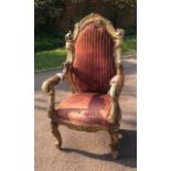 AN 18TH CENTURY ITALIAN OPEN ARMCHAIR The carved giltwood frame of organic form with over scroll