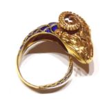 A VICTORIAN YELLOW METAL AND ENAMEL ETRUSCAN FORM RAMS HEAD RING Having blue email scale pattern
