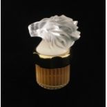 LALIQUE, A FROSTED GLASS PERFUME BOTTLE Having a frosted glass lion head with clear glass base
