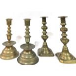 TWO PAIRS OF 19TH CENTURY BRASS CANDLESTICKS One pair being of spherical form with drip pans. (