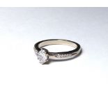AN 18K WHITE GOLD AND 0.40 MARQUISE CUT DIAMOND SOLITAIRE RING On diamond shoulders (size L). weight