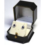 A PAIR OF 18CT WHITE GOLD, SAPPHIRE AND DIAMOND EARRINGS The single pear cut sapphire edged with