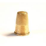 A 19TH CENTURY FRENCH 18CT GOLD THIMBLE Having chased decoration and scrolled edge. (weight approx