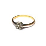 A VINTAGE 18CT GOLD AND DIAMOND DAISY RING The arrangement of round cut diamonds (size M). (weight