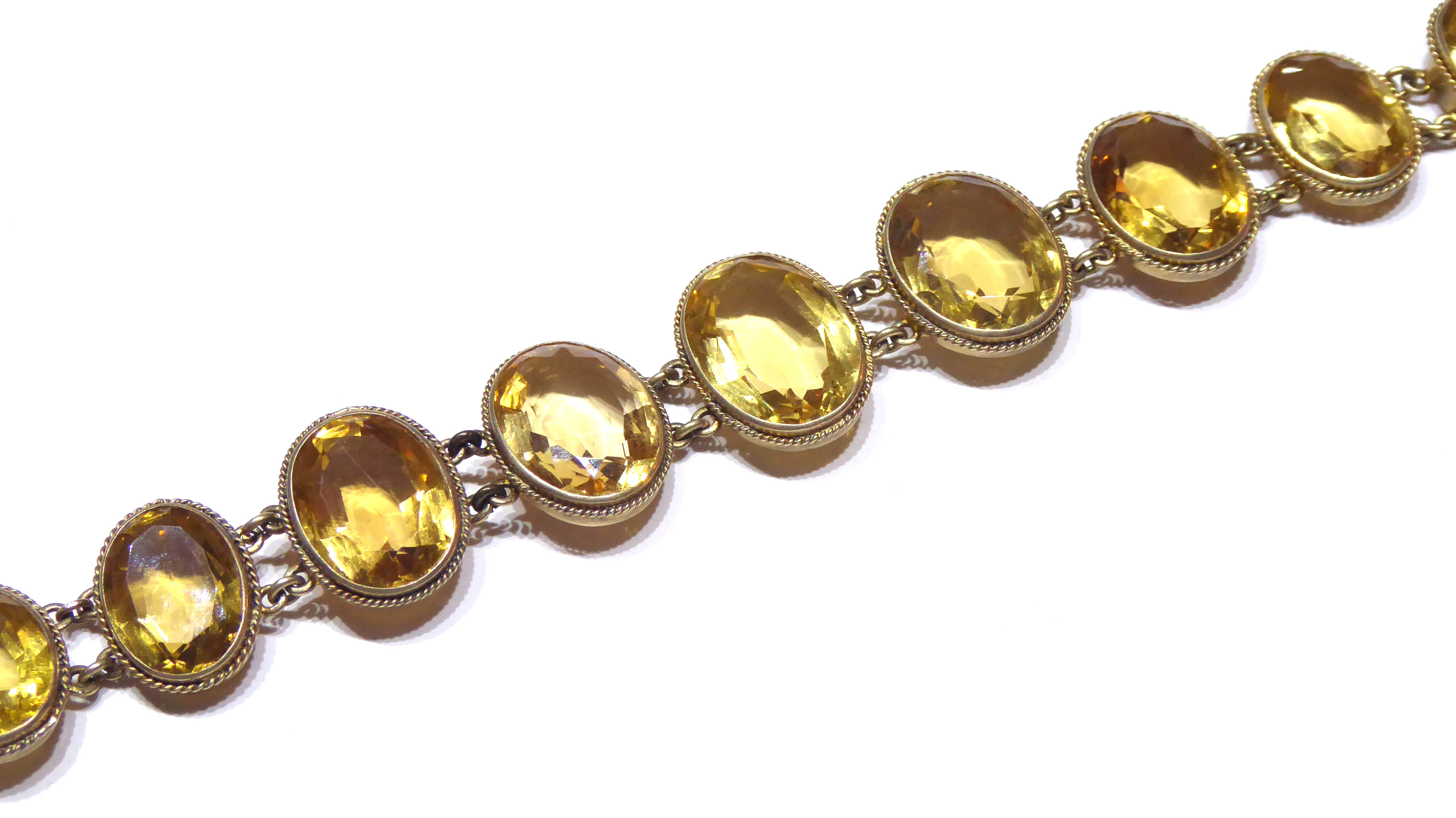 A VICTORIAN YELLOW METAL AND CITRINE BRACELET Having an arrangement of oval cut graduating - Image 2 of 2