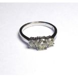 AN 18K WHITE GOLD RING SET WITH THREE ROUND CUT DIAMONDS The central stone weighing 1ct (size N). (