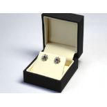 A PAIR OF 18CT WHITE GOLD, SAPPHIRE AND DIAMOND STUD EARRINGS The single sapphire edged in