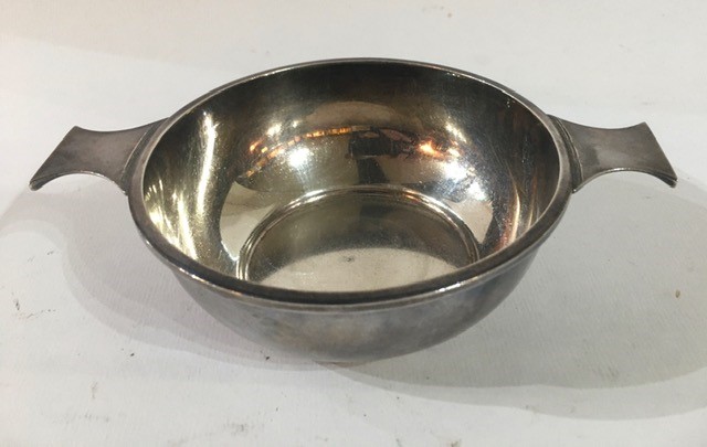 A 20TH CENTURY SILVER QUAICH Having twin handles, hallmarked Birmingham, 1945 and later inscription.