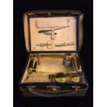 ASPREY, AN EDWARDIAN SILVER GILT TRAVELLING VANITY CASE Comprising a hairbrush, manicure set,