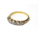 AN EARLY 20TH CENTURY 18CT GOLD AND DIAMOND FIVE STONE RING The arrangement of graduating round