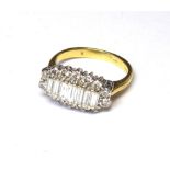 AN 18CT GOLD AND DIAMOND CLUSTER RING The arrangement of baguette stones edged with round cut