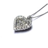 AN 18K WHITE GOLD HEART SHAPED PENDANT Encrusted with 1ct of baguette and round cut diamonds 2cm