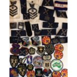 A COLLECTION OF CLOTH NAVAL BADGES Three stripes on blue ground, together with a collection of