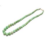 A 19TH CENTURY 9CT GOLD AND CHINESE JADE NECKLACE Having a strand of graduating spherical jade