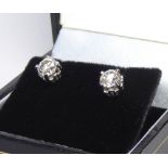 A PAIR OF 18CT WHITE GOLD AND ROUND CUT DIAMOND STUD EARRINGS. (total diamond weight 1.3ct) Colour H