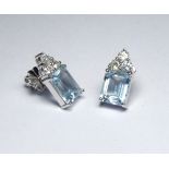 A PAIR OF 18K WHITE GOLD ART DECO DESIGN EARRINGS Set with 5.80ct aquamarines and 0.98ct