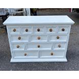 A PAINTED PINE BANK OF DRAWERS. (h 86cm x w 120cm x d 49cm)