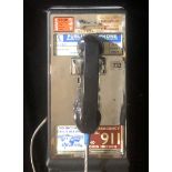 A VINTAGE AMERICAN WALL HANGING PAY PHONE. (53cm x 20cm x 17cm)