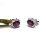 A PAIR OF 18K EARRINGS, SET WITH 3.61CT RUBIES Surrounded by 0.57 diamonds.