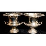 A PAIR OF 20TH CENTURY SILVER PLATED WINE BOTTLE HOLDERS Campaign urn form, with scrolled rim,