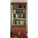 A REGENCY DESIGN YEW BOOKCASE With decorative cornice above open adjustable shelves, brushing