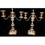 A PAIR OF 20TH CENTURY SILVER PLATE ON COPPER CANDELABRAS Having floral form finials, twin branch