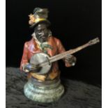 A COLD PAINTED BRONZE, AFRICAN AMERICAN BANJO PLAYER On circular green marble base. (24cm)