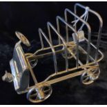 A SILVER PLATED NOVELTY TOAST RACK IN THE FORM OF A VINTAGE MOTOR CAR Marked 'Van Bergh' to base. (