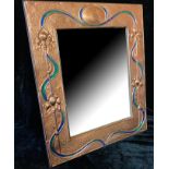 AN ART NOUVEAU DESIGN COPPER AND ENAMEL EASEL MIRROR scrolled tulips with enamel swags on wood easel