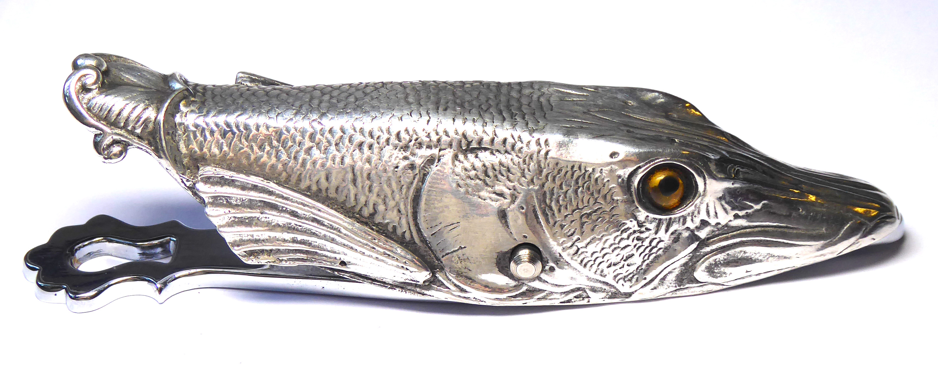 A SILVER PLATED LETTER CLIP IN THE FORM OF A PIKE FISH Having glass set eyes with hinged back. (